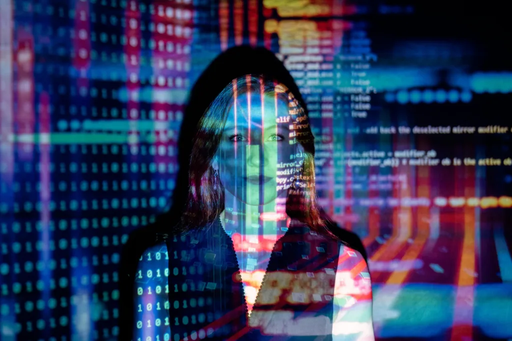 pexels-photo-3861969-3861969 A woman with digital code projections on her face, representing technology and future concepts.
